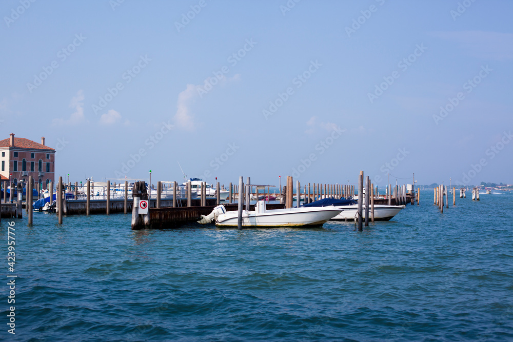 Beautiful mediterranean sea view on Venice lagoon and pier with yachts in Italy in sunny day