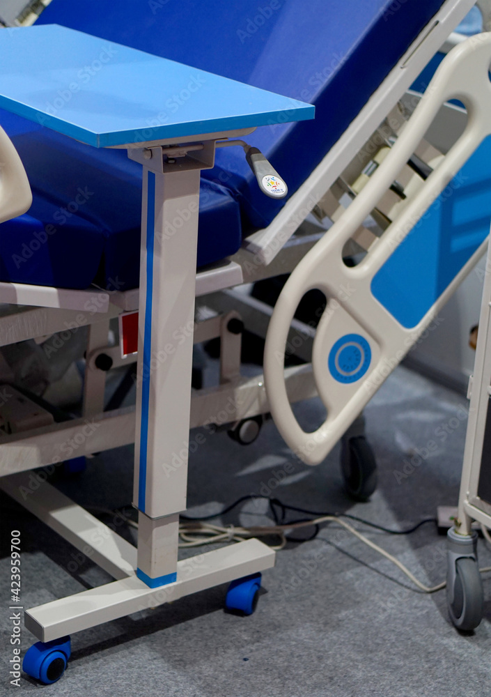 view of a Metallic hospital bed  with controls for patients comfort