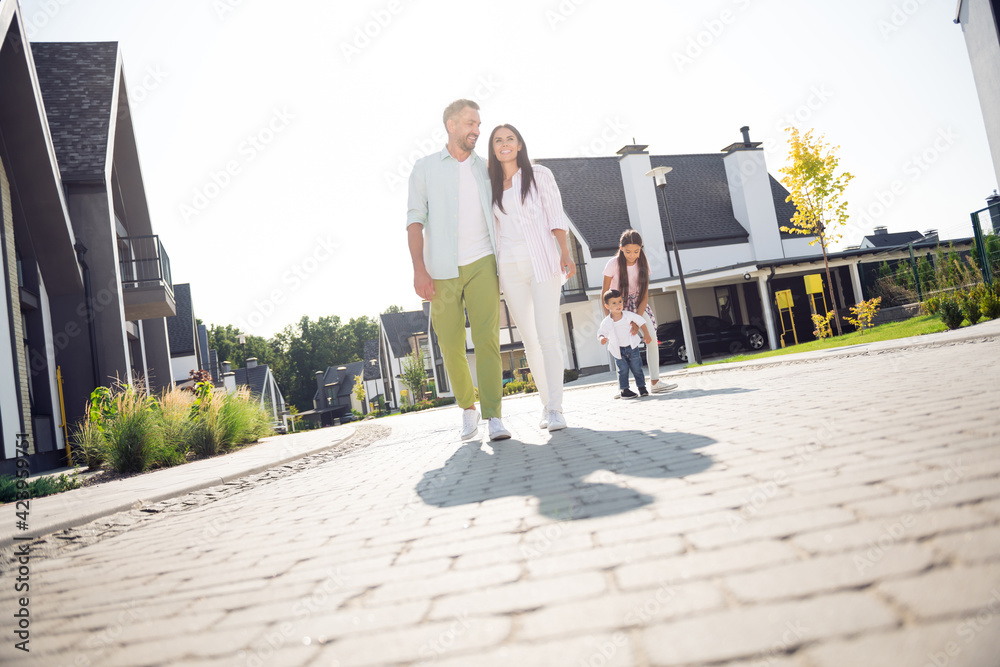 Full size photo of pretty lady hug handsome guy little kids walking behind spend nice sunny day outdoors