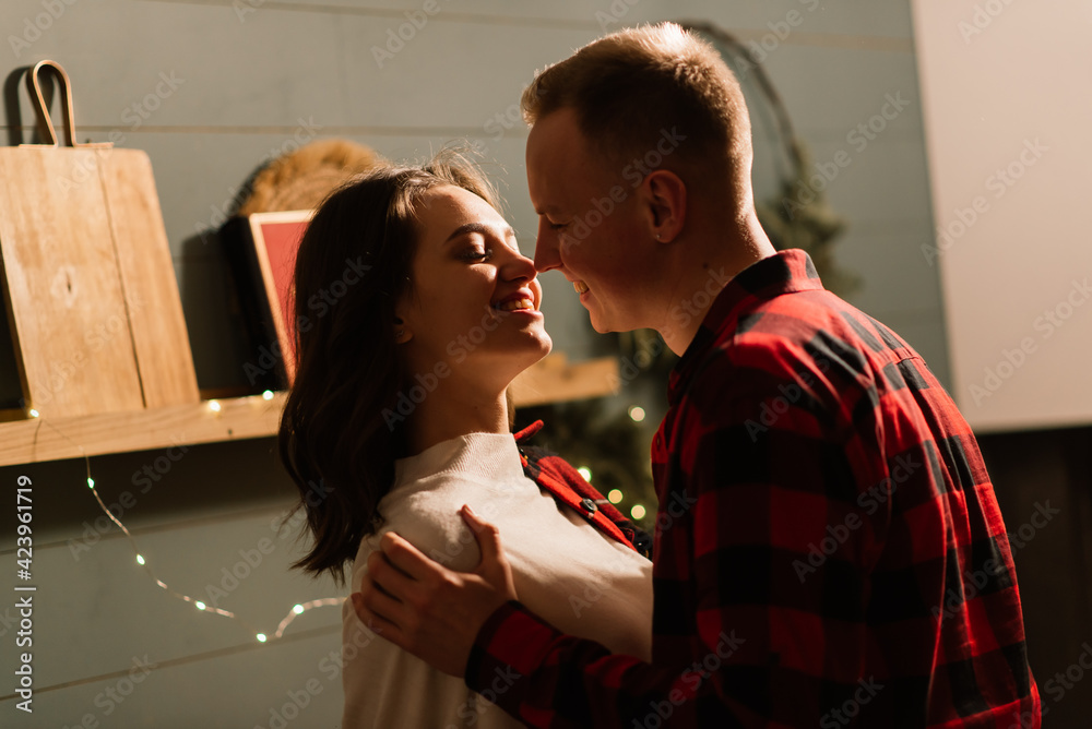 Love, christmas, couple, proposal and people concept - happy man giving diamond engagement ring to woman at home
