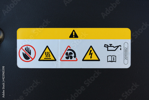 Warning label in new car engine bay