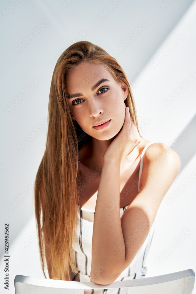 Close up portrait of pretty young woman looking to camera with sun lights on background Close up portrait of pretty young woman looking to camera with sun lights on background