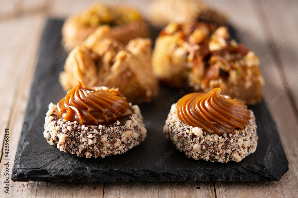 Assortment of Ramadan dessert baklava on wooden table. Traditional arabic sweets Assortment of Ramadan dessert baklava on wooden table. Traditional arabic sweets