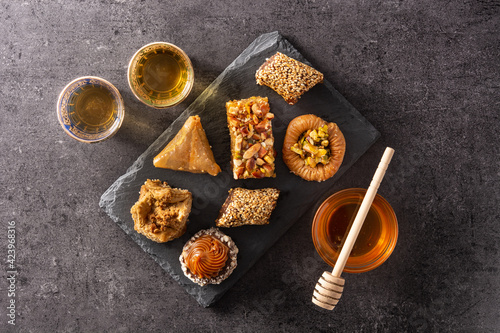 Assortment of Ramadan dessert baklava on black background. Top view. traditional arabic sweets photo