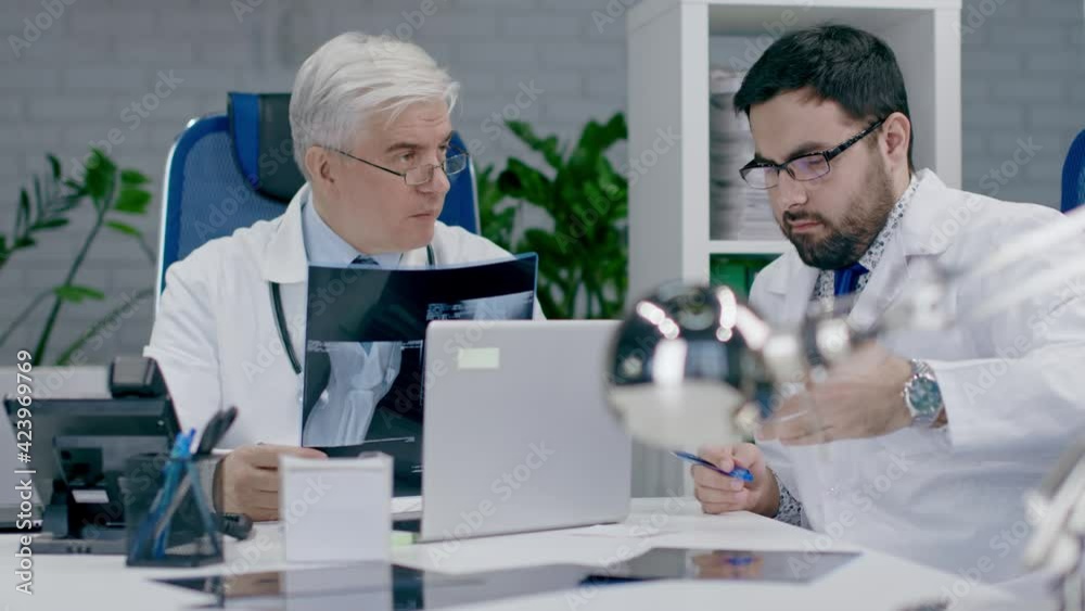 Teamwork of doctors in the office. X-ray consultation. Teamwork of doctors in the office. X-ray consultation.