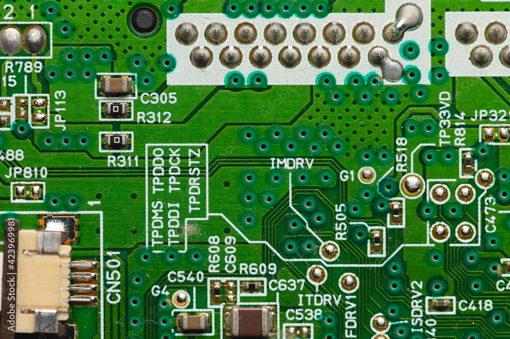 Green electronic board with radioelements close-up. Background for the theme of electronics and high tech equipment Green electronic board with radioelements close-up. Background for the theme of electronics and high tech equipment
