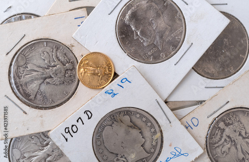 Wallpaper Mural Old coin collection in protective wrappers with a gold liberty coin loose on top. Torontodigital.ca