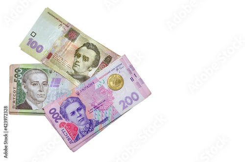 Modern ukrainian money - hryvnia. Stack of 500, 200, 100 banknotes and one coint (kopijka) Flat lay, top view. Isolated on white background  with free space for your text. Money and financial concept