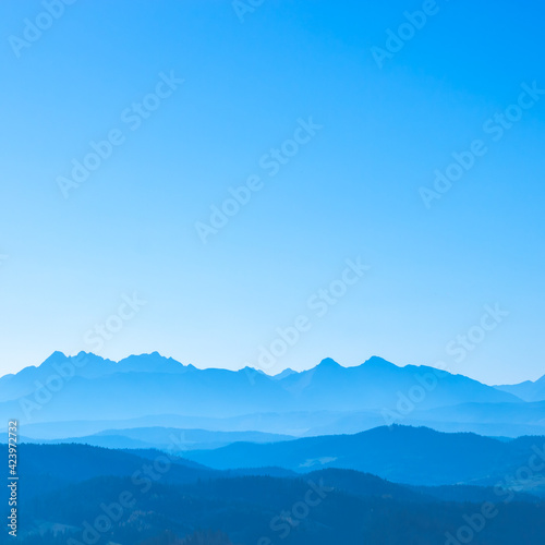 Blue surreal mountains against the backdrop of a cyan sky, fantastic fairytale mountain landscape