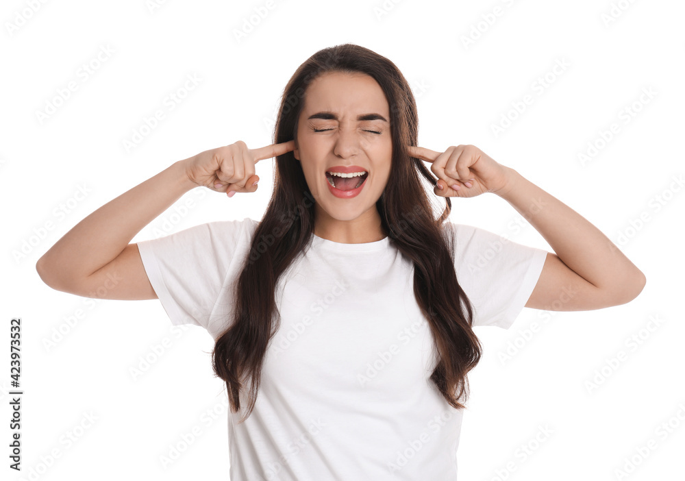 Emotional young woman covering ears with fingers on white background Emotional young woman covering ears with fingers on white background