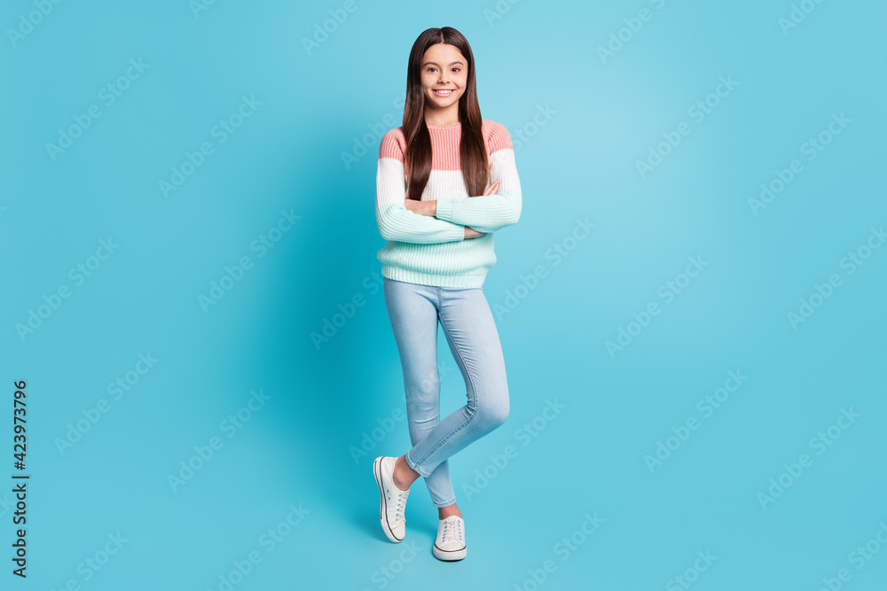 Full size photo of young cheerful girl happy positive smile confident folded hands isolated over blue color background Full size photo of young cheerful girl happy positive smile confident folded hands isolated over blue color background
