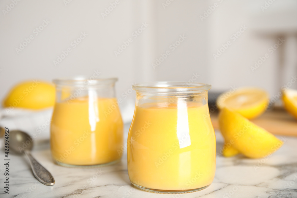 Delicious lemon curd on white marble table Delicious lemon curd on white marble table