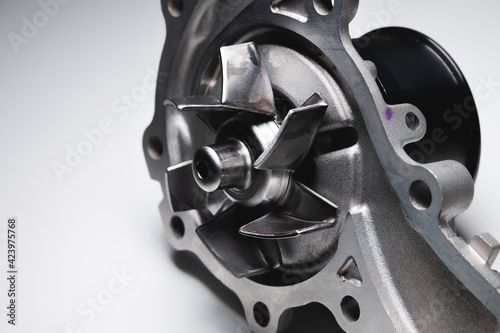 Water pump of the internal combustion engine cooling system. Contrasting on a gray gradient
