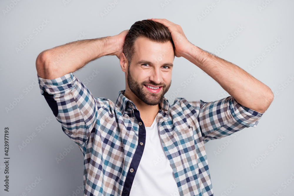Photo portrait of confident smiling guy looking handsome demonstrating haircut isolated on grey color background Photo portrait of confident smiling guy looking handsome demonstrating haircut isolated on grey color background