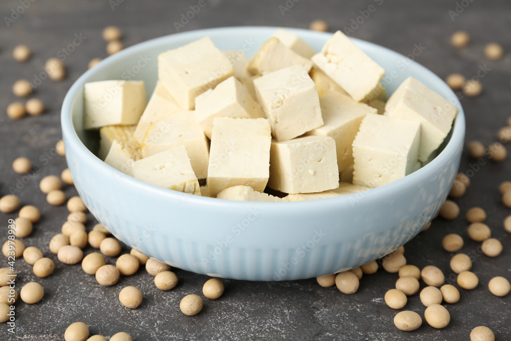 Cut tofu and soya beans on grey table, closeup Cut tofu and soya beans on grey table, closeup