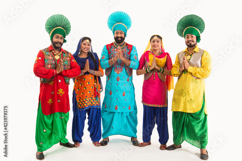 A Troupe of Punjabi Folk Dancers greeting with Namaste.	 photo