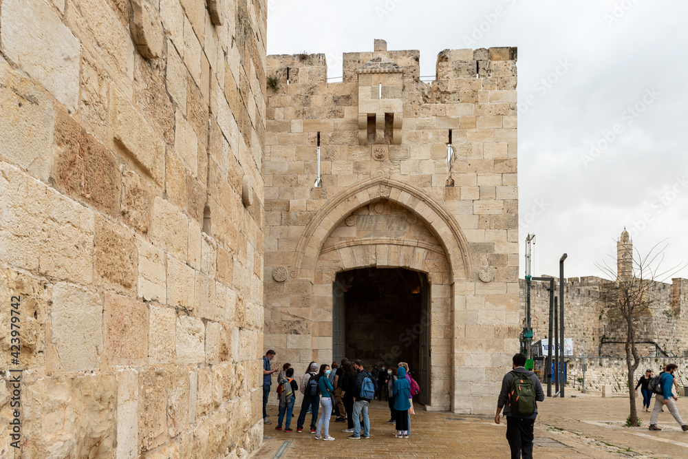 Few tourists wait for a tour on a rainy day near the Yafo Gate in the old city of Jerusalem, Israel.