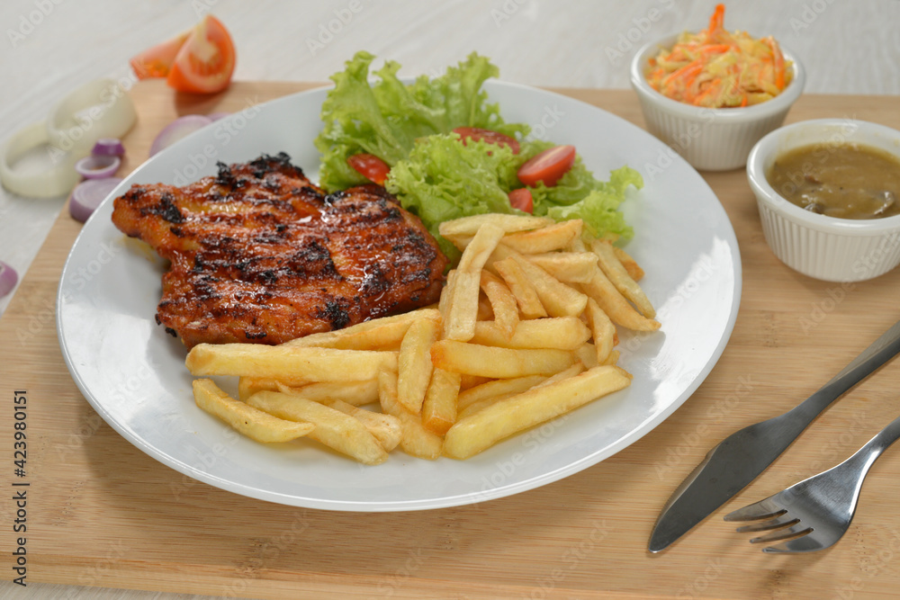 delicious plate of western food chicken chop with fries and salad