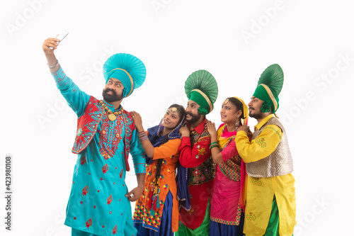 A Troupe of Punjabi Folk Dancers clicking a selfie together. 