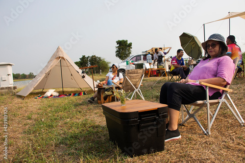 Travelers thai people travel visit sit on chair of cafe coffee shop outdoor and tent camping beside irrigation canal at Bangbuathong city rural countryside on March 13, 2021 in Nonthaburi, Thailand