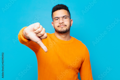 young hispanic man angry expression photo