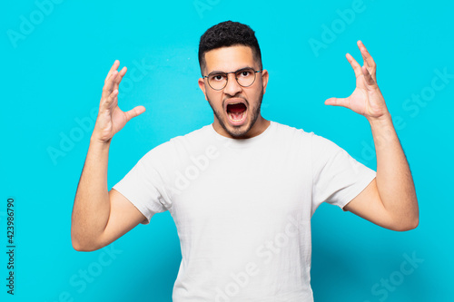 young hispanic man angry expression photo