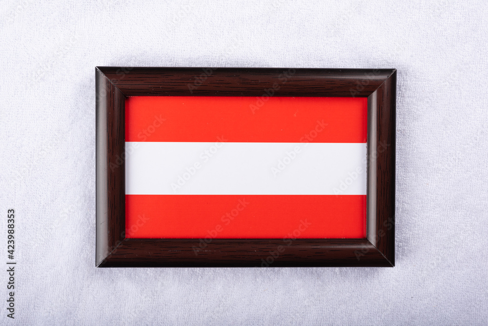 Austria flag in a realistic frame on white cloth background flat lay photo Austria flag in a realistic frame on white cloth background flat lay photo