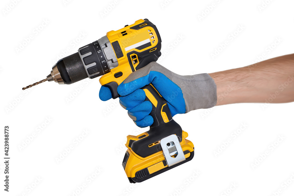 A man's gloved hand holds a drill