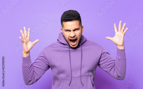 young hispanic athlete man angry expression photo