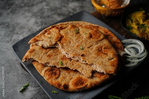 Wholegrain wheat Naan -Indian flat bread served with chicken korma, selective focus
