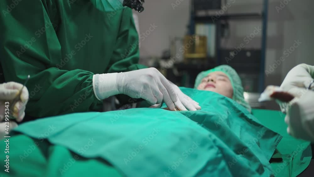 Operating Human Using Razor Knife Professional doctor in the uniform wearing face mask and glove using ...