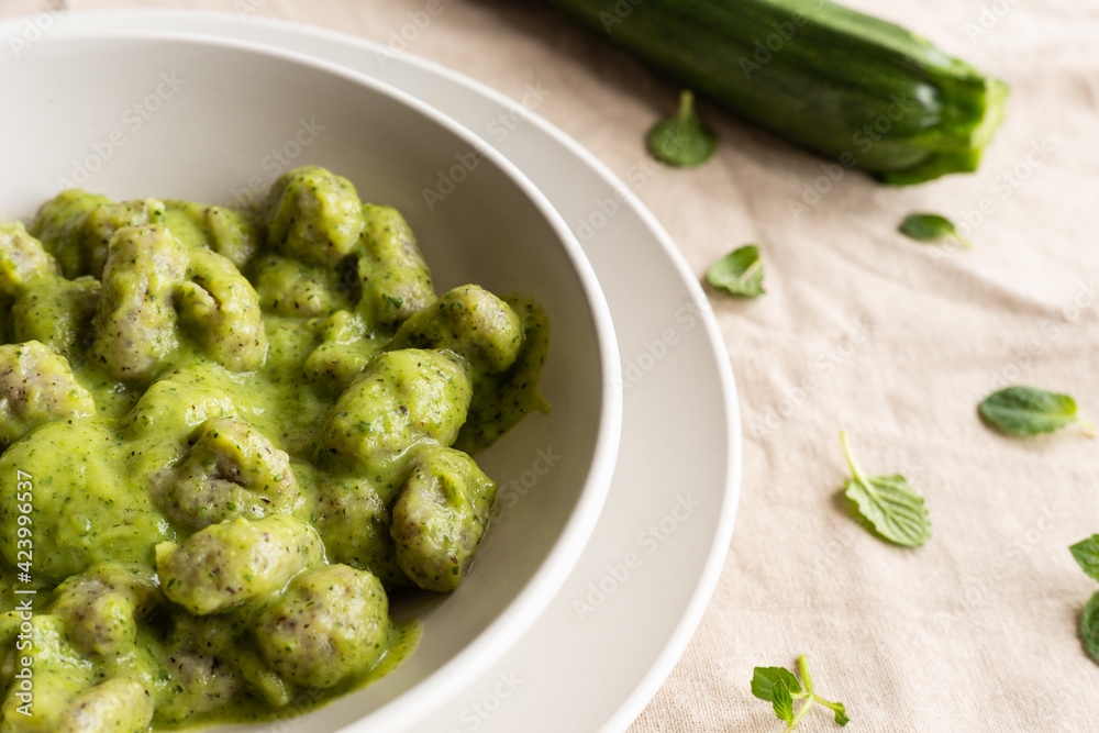 Homemade gnocchi with zucchini cream, typical Italian food Homemade gnocchi with zucchini cream, typical Italian food