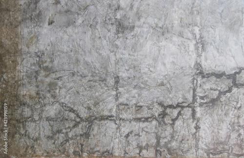 Concrete wall texture with cracks, dirt and paint splash.