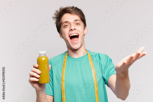 young teenager man surprised expression and holding a soothy. diet concept photo