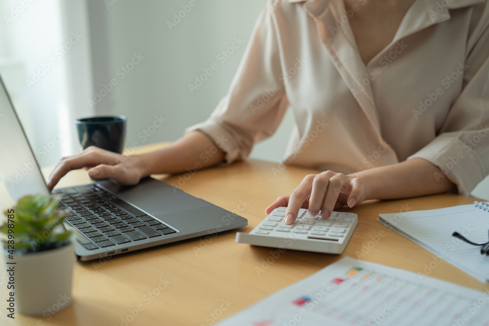 Fototapeta premium Businesswoman calculating budget numbers, Invoices, and financial adviser working.