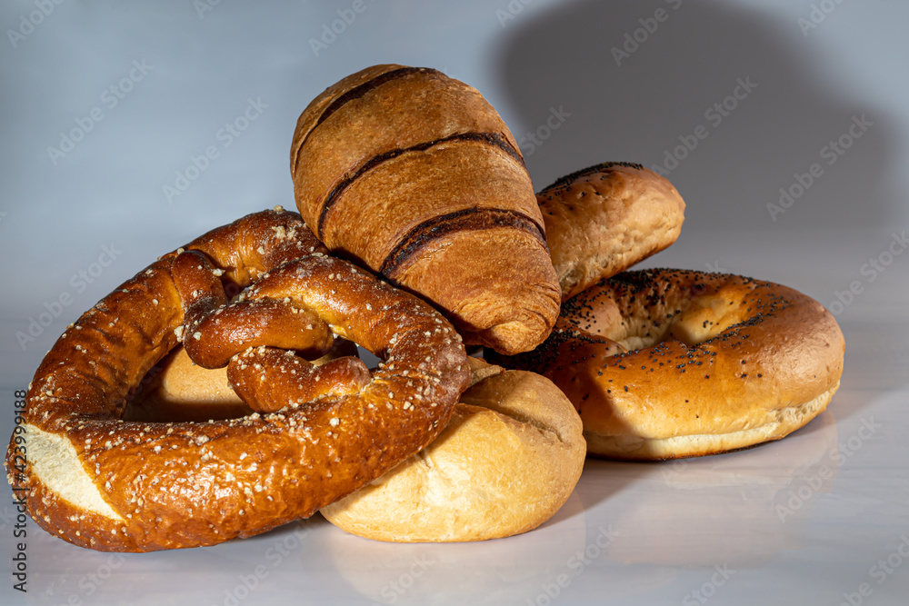 Sweet yeast baked goods. Bagels, donuts croissants pretzels. On a light background. Sweet yeast baked goods. Bagels, donuts croissants pretzels. On a light background.