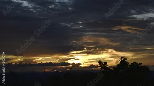 Amazing Timelapse of a sunset with clouds and moutains - sun light reflections - stable