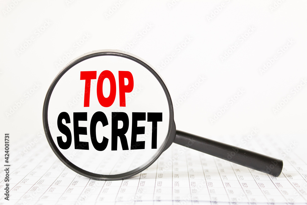 words TOP SECRET in a magnifying glass on a white background. business concept words TOP SECRET in a magnifying glass on a white background. business concept