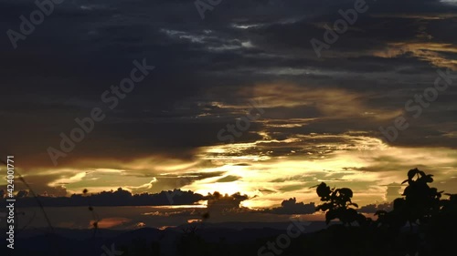 Timelapse of a Sunset over the mountains with clouds in 4k zoom out