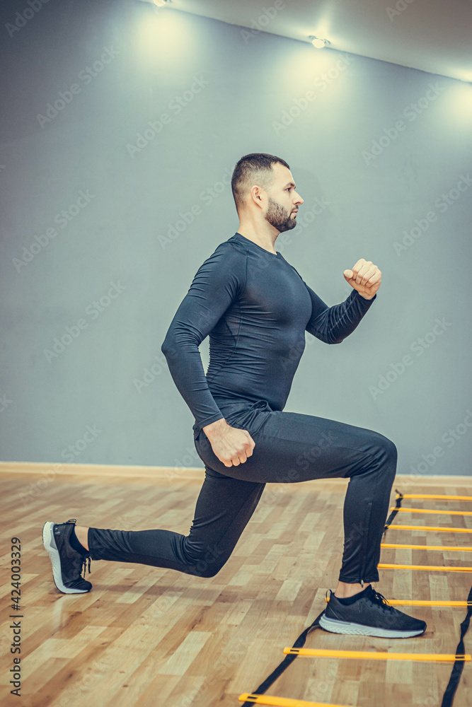 Fitness concept. Portrait of a handsome man doing run and plank at gym.
