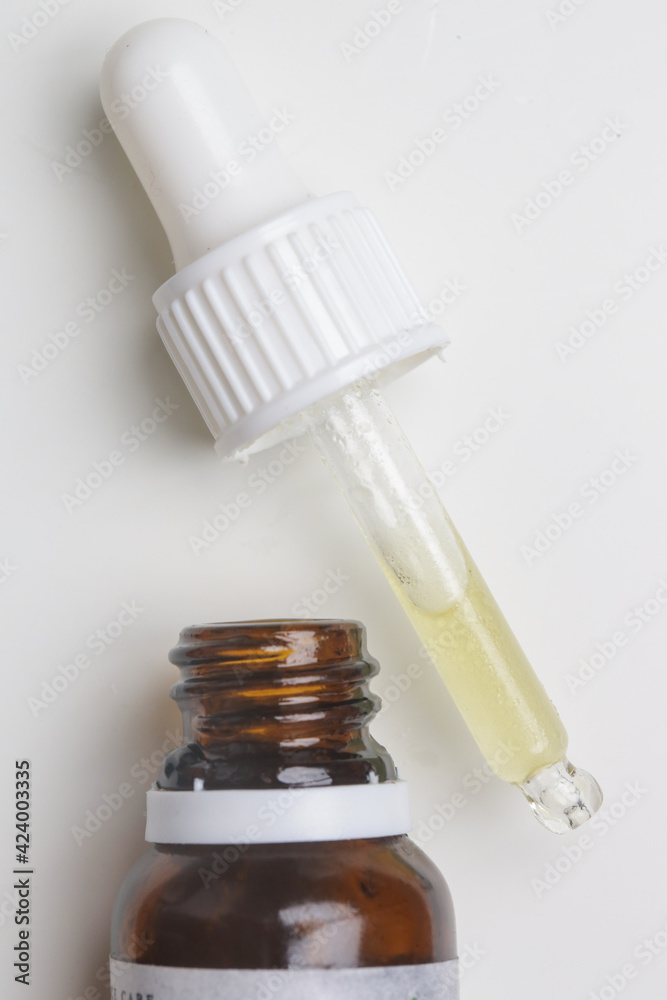 Nourishing and hydrating facial serum in glass dropper, close up image