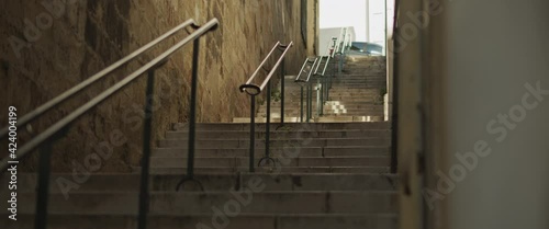 Narrow old street with stairs and railing in Lisbon, Portugal. Slow motion.