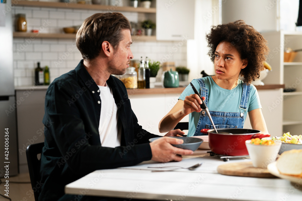 Loving couple eating lunch together at home. Husband and wife enjoying in tasty meal. Loving couple eating lunch together at home. Husband and wife enjoying in tasty meal.