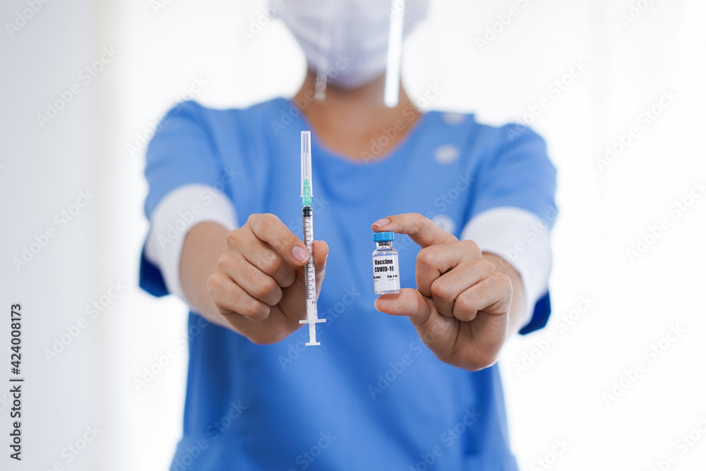 Doctor nurse and scientist in laboratory holding a syringe with liquid vaccines fight against virus covid-19 corona virus for children or older adults diseases medical care science concept Doctor nurse and scientist in laboratory holding a syringe with liquid vaccines fight against virus covid-19 corona virus for children or older adults diseases medical care science concept