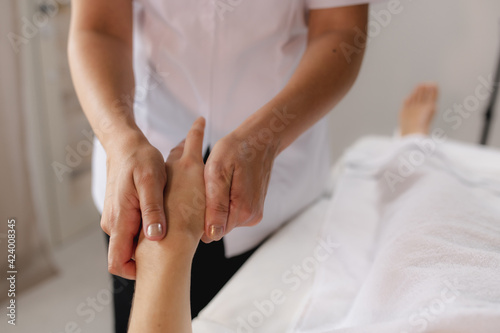 Unrecognizable women in a spa. Therapist making relaxing hand massages.