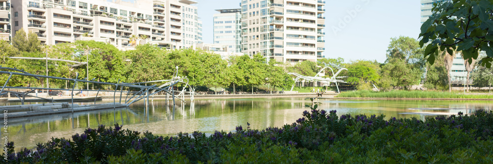 An artificial reservoir in a city park. Resting place for the townspeople and embracing birds. Barcelona, Spain, Diagonal Mar Park. An artificial reservoir in a city park. Resting place for the townspeople and embracing birds. Barcelona, Spain, Diagonal Mar Park.