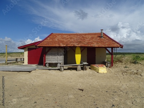 House in dune landscape with ragged cloud