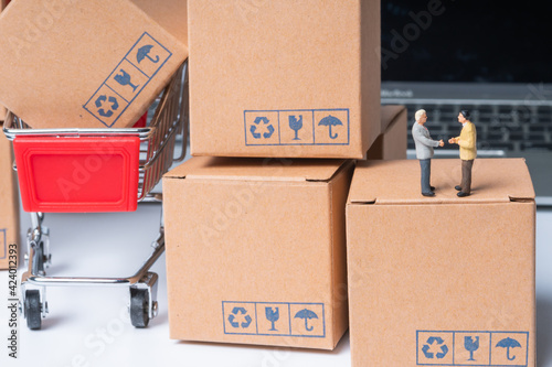 miniature people sitting on parcel box, online shopping concept © kwanchaift