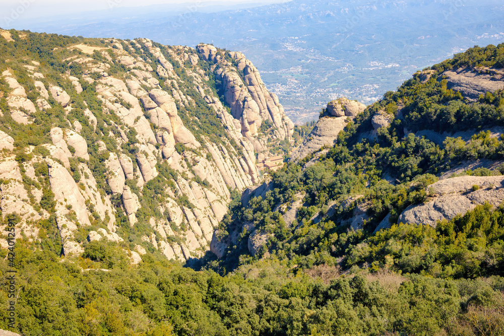 Fototapeta premium View of the valley where the Montserrat Monastery tourist-religious complex is located from the Saint Joan funicular. Montserrat massif natural park, Catalonia, Spain