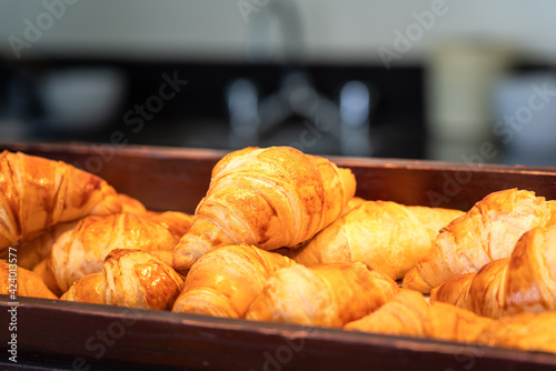 Set of freshness baked original "Croissant" in the tray, ready for customer in bakery shop. Bakery food object photo. Selective focus.